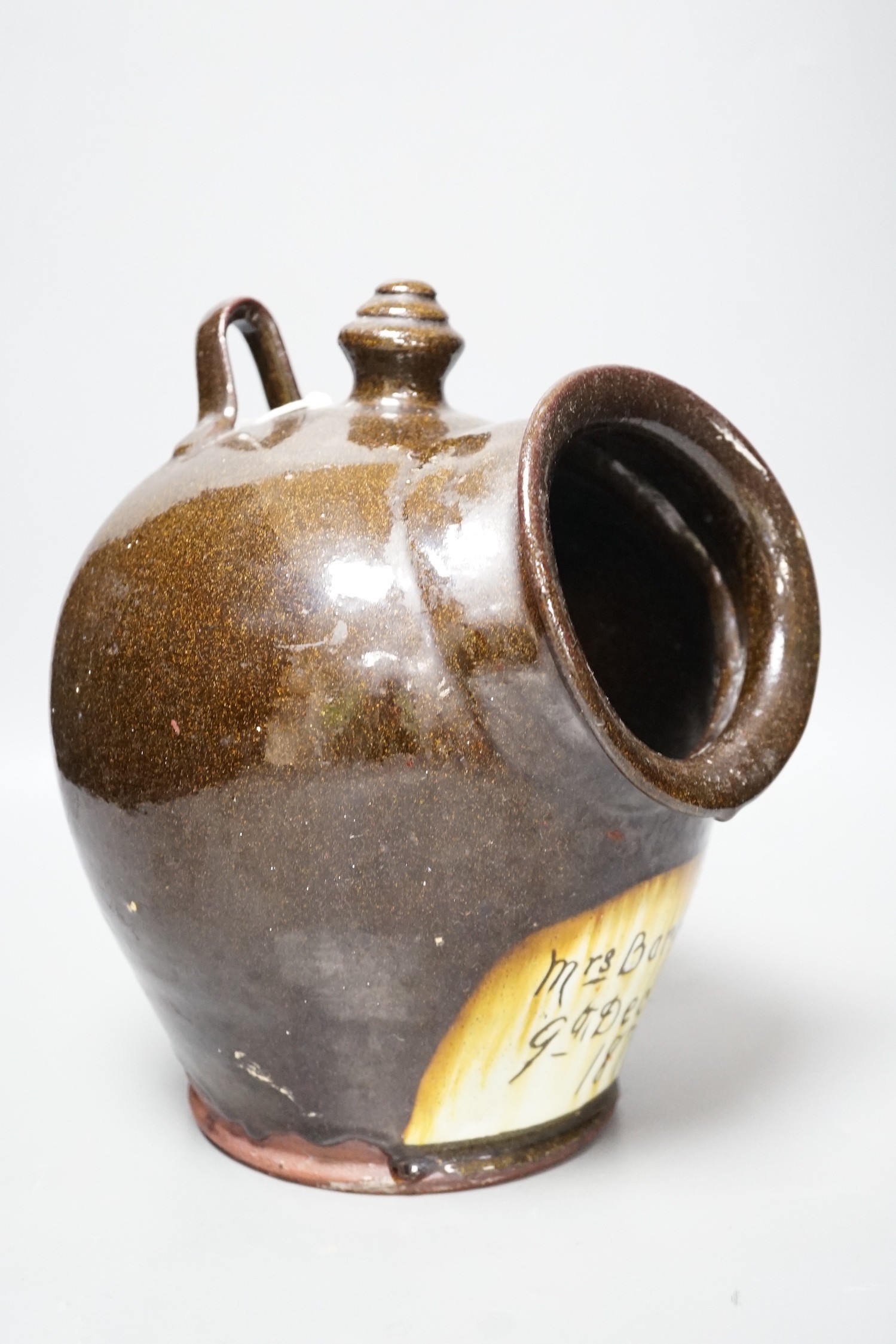 A glazed stoneware salt dispenser, inscribed in slip Mrs Barbour 9th Decr. 1879, 25cm